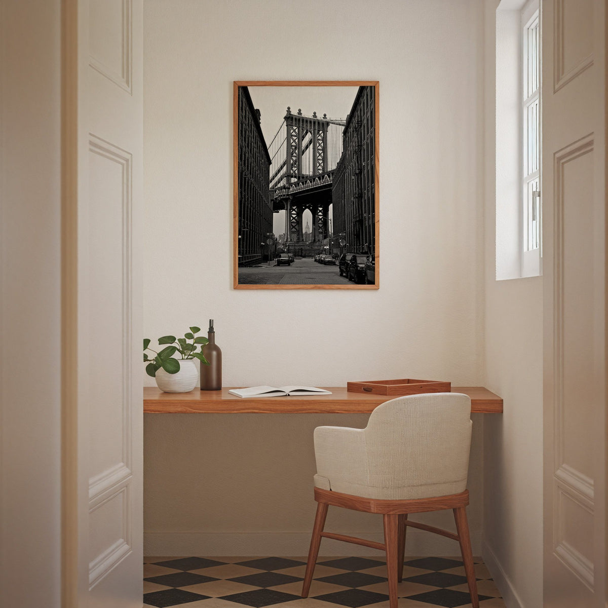Manhattan Bridge between brick buildings print in an oak frame above a home office desk nook