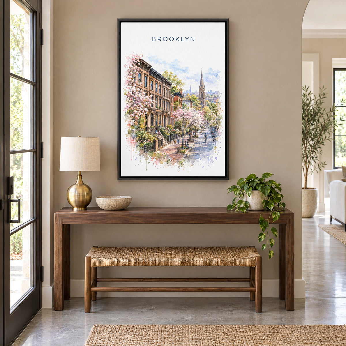 Brooklyn watercolor print as a black floater canvas above a walnut console and woven bench in an entryway