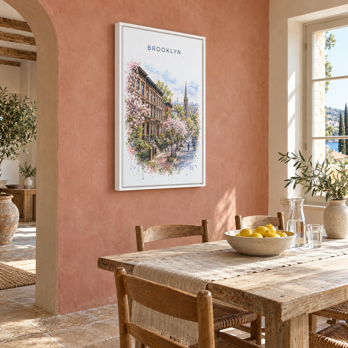Brooklyn watercolor print as a white floater canvas on a terracotta wall above a rustic dining table