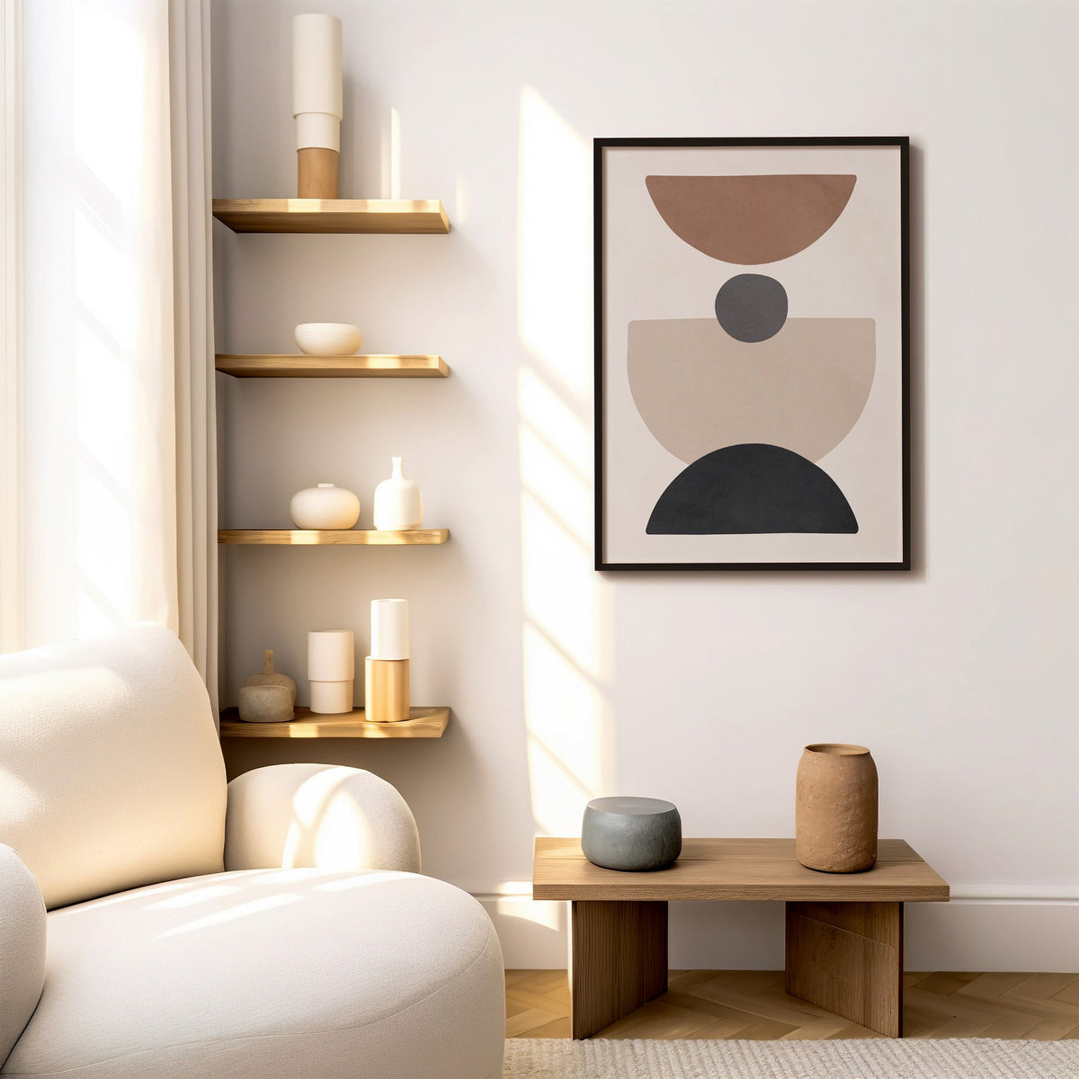 Brown bowl and black arch stacked shapes print in a black frame above a low wood bench beside floating oak shelves