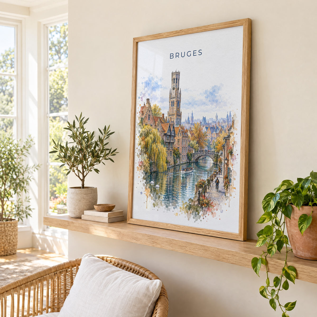 Bruges watercolor print in an oak frame on a picture ledge in a sunlit sunroom