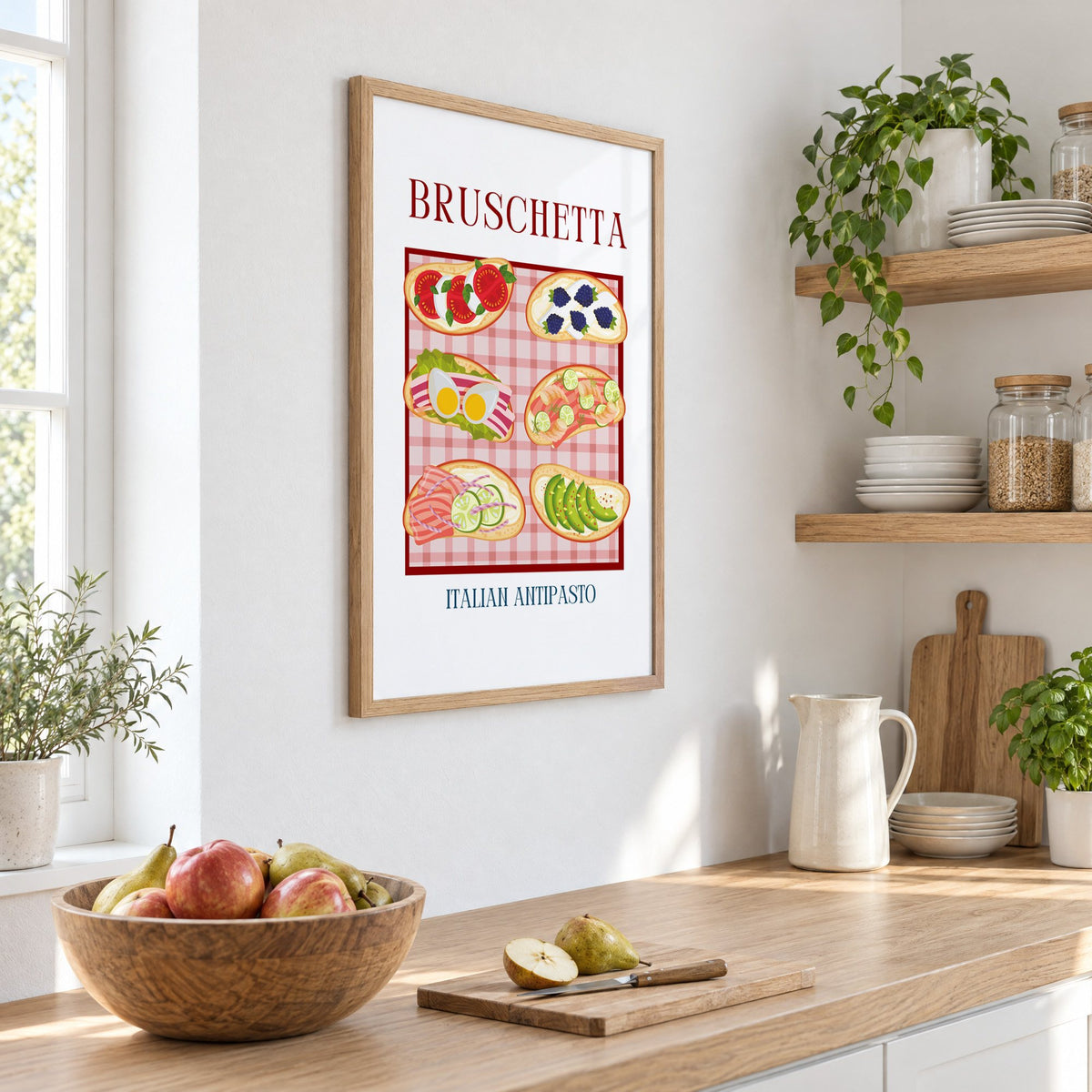BRUSCHETTA six toasts pink gingham print in an oak frame on a white kitchen wall above a counter with apples and pears, seen at an angle