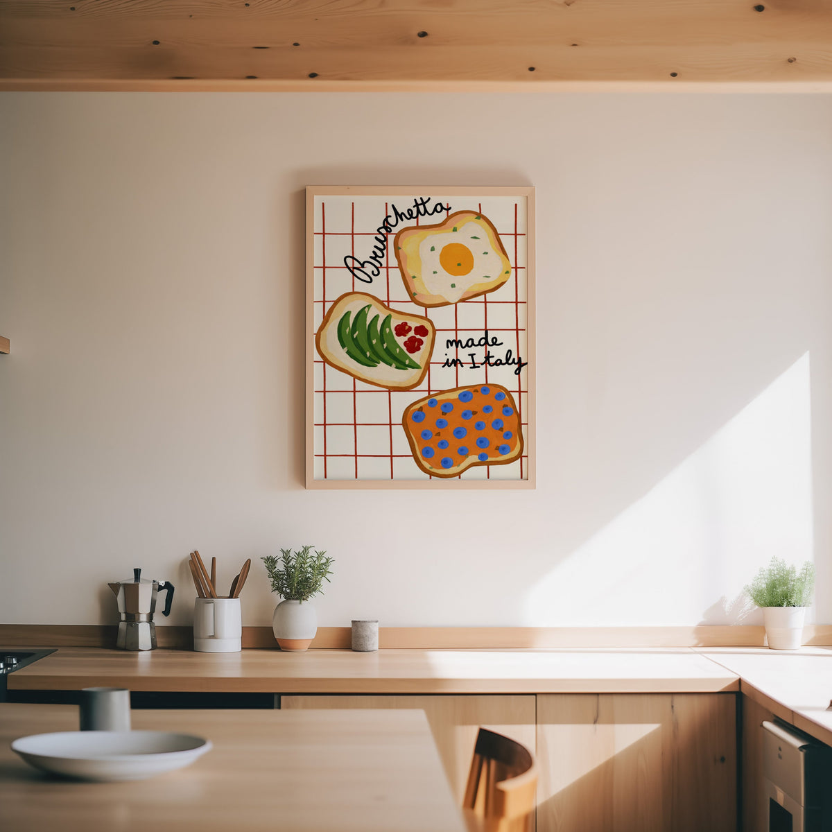 Bruschetta print in an oak frame above a wood counter with a moka pot and herbs