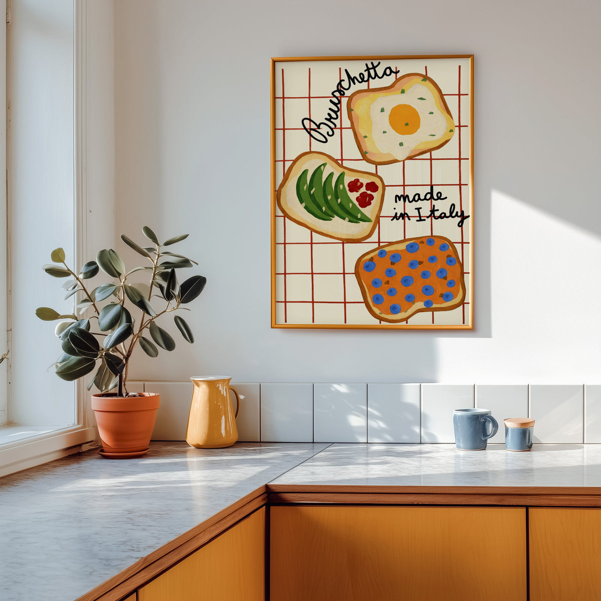 Bruschetta print in a gold frame above a marble counter with a yellow ceramic jug