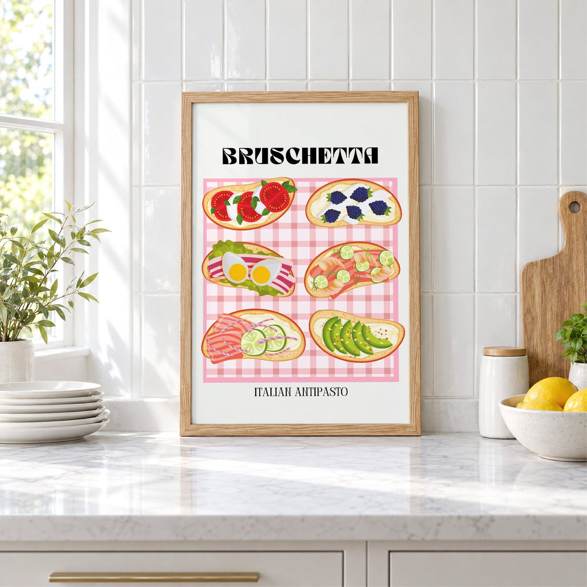 BRUSCHETTA pink gingham print in an oak frame leaning on a marble counter by white tiles and lemons