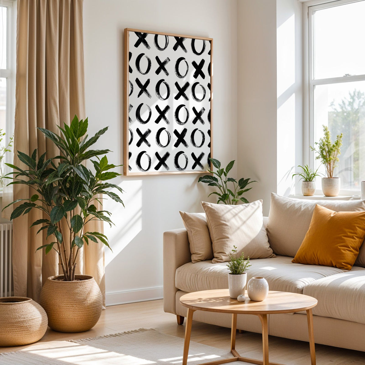 Hand-brushed XOXO pattern print in an oak frame above a cream sofa beside woven planters