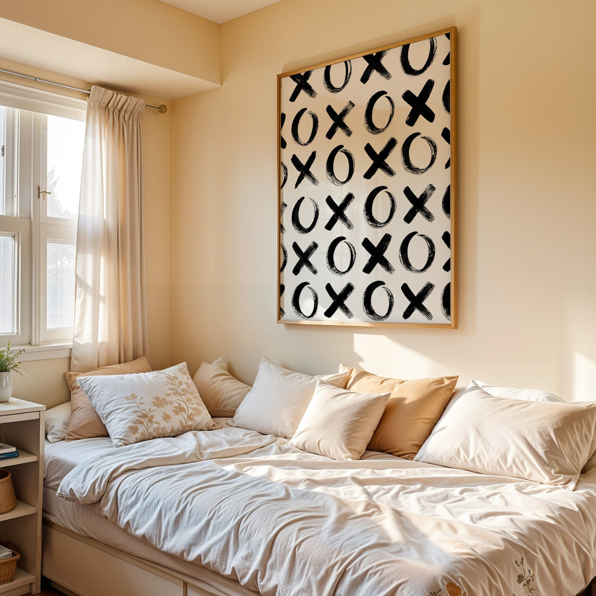 Hand-brushed XOXO pattern print in an oak frame above a cream daybed in a sunny bedroom