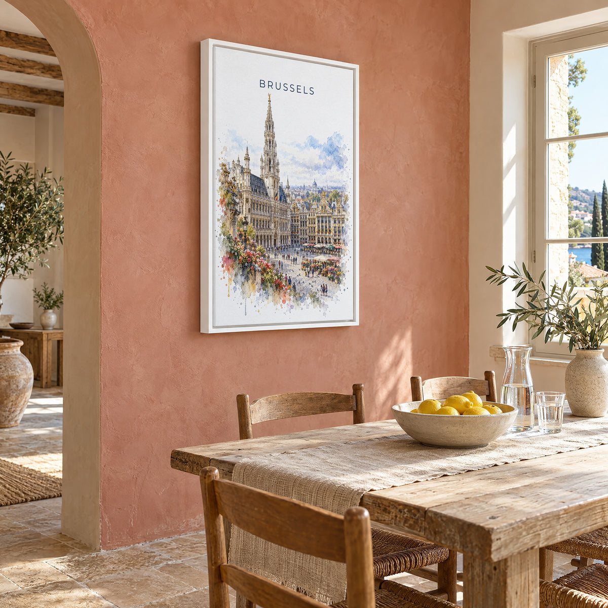 Brussels watercolor print as a white floater canvas on a terracotta wall above a rustic dining table