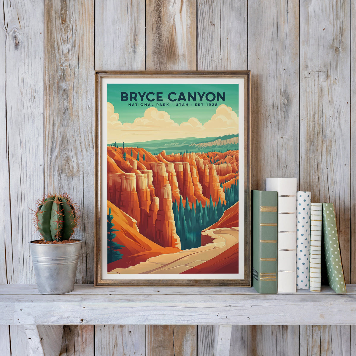 Bryce Canyon poster in an antique gold frame against whitewashed farmhouse planks beside books and a cactus