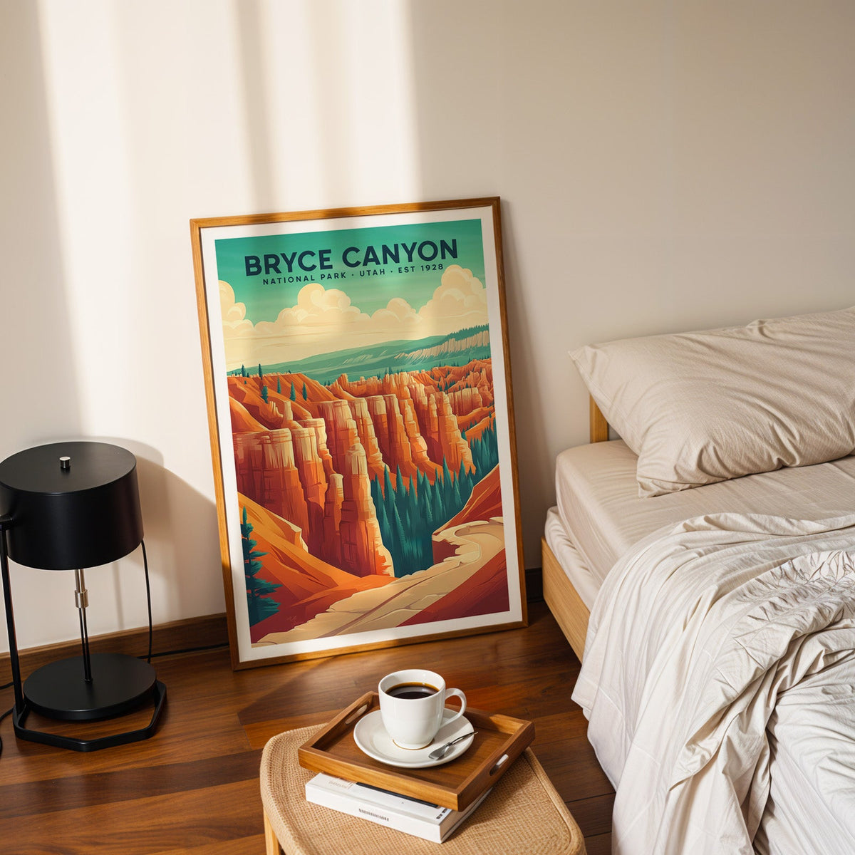 Bryce Canyon National Park print in an oak frame leaning on a bedroom floor beside the bed and a tray