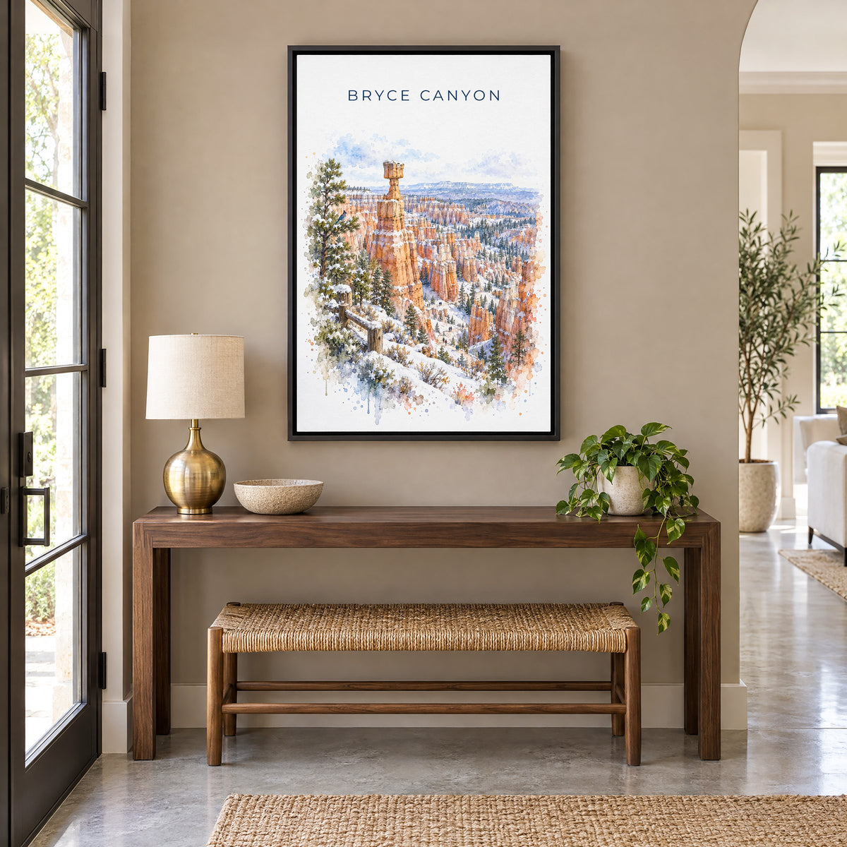 Bryce Canyon National Park watercolor print as a black floater canvas above a walnut console and woven bench in an entryway