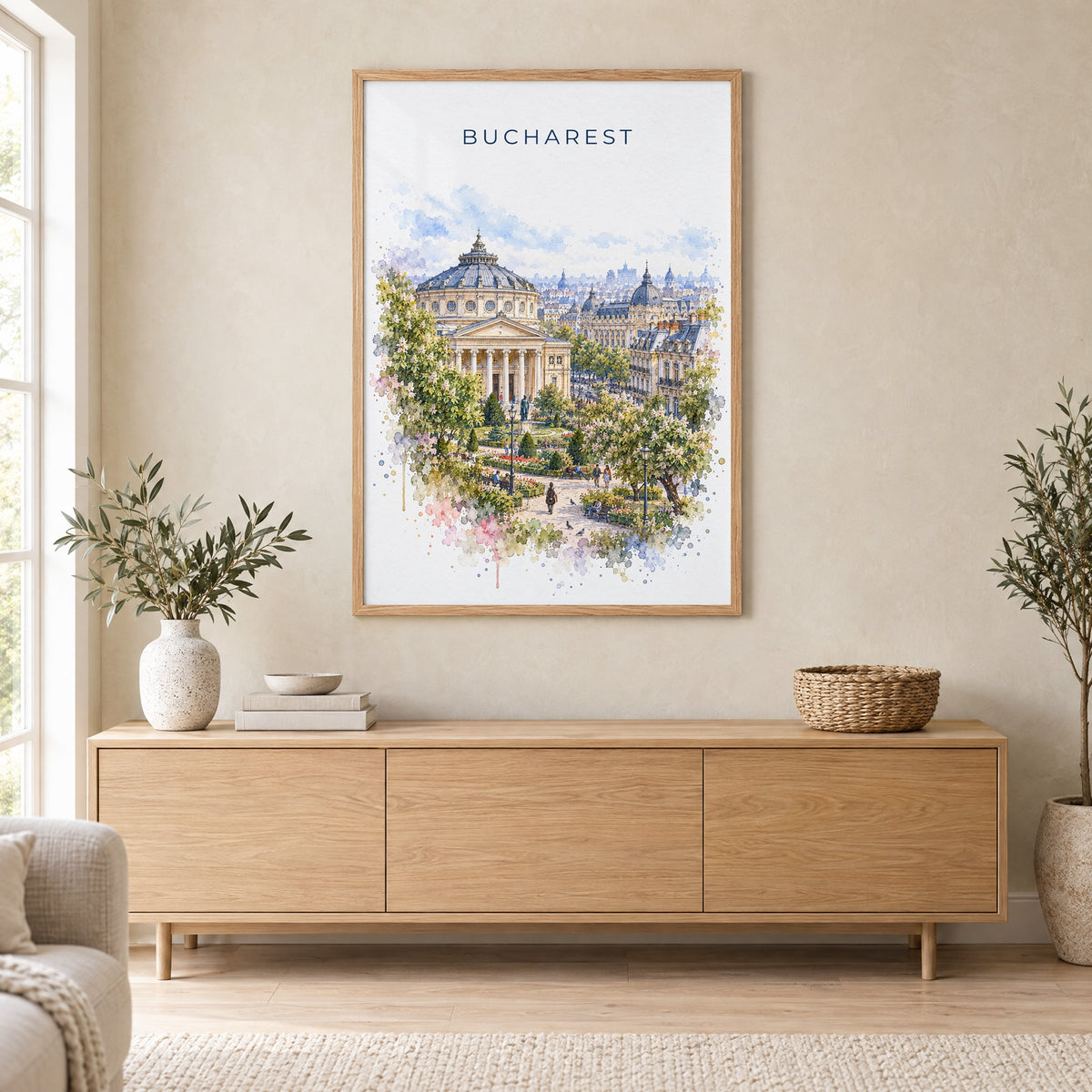 Bucharest watercolor print in an oak frame above a light wood sideboard in a Scandinavian living room