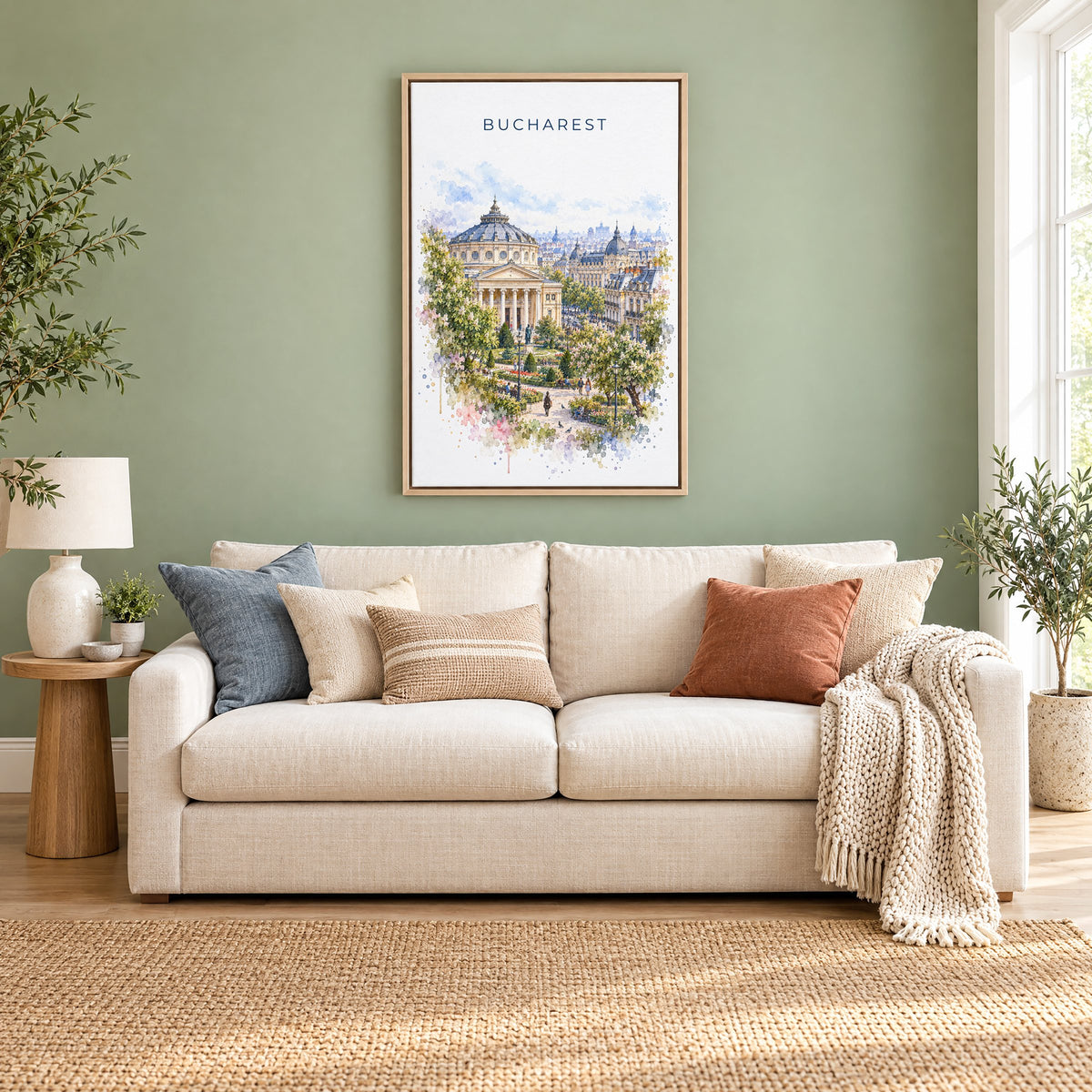 Bucharest watercolor print as a natural floater canvas above a cream linen sofa on a sage green wall