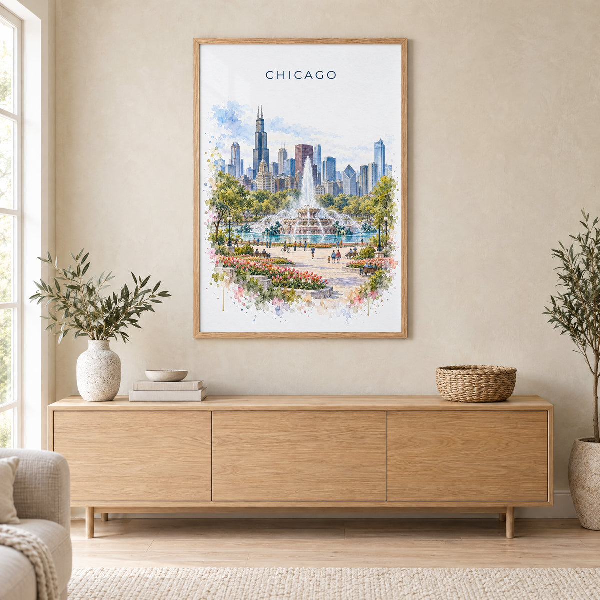 Buckingham Fountain Chicago watercolor print in an oak frame above a light wood sideboard in a Scandinavian living room