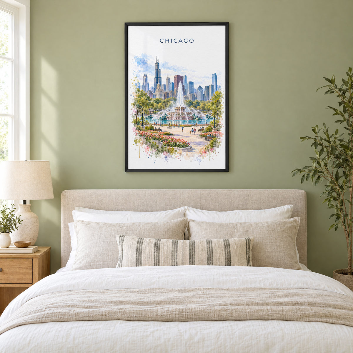 Buckingham Fountain Chicago watercolor print in a black frame above an upholstered headboard in a sage green bedroom