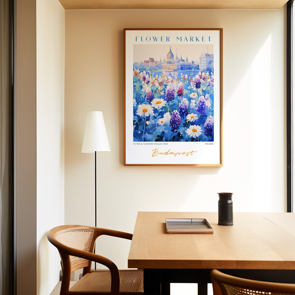Budapest flower market print in an oak frame above a dining table and cane chair