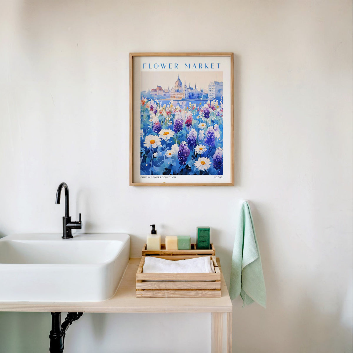 Budapest flower market print in an oak frame above a white bathroom sink with folded towels