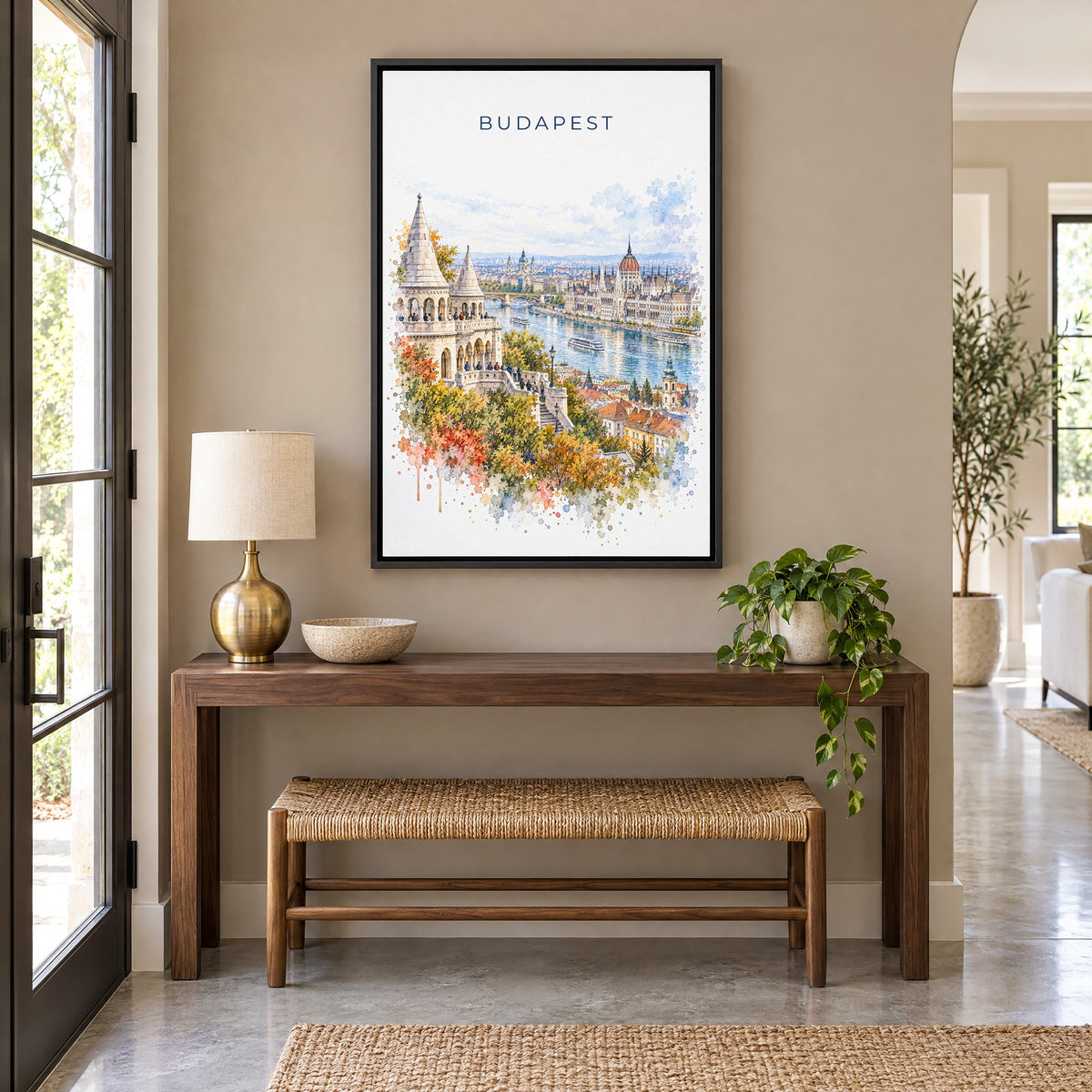 Budapest watercolor print as a black floater canvas above a walnut console and woven bench in an entryway