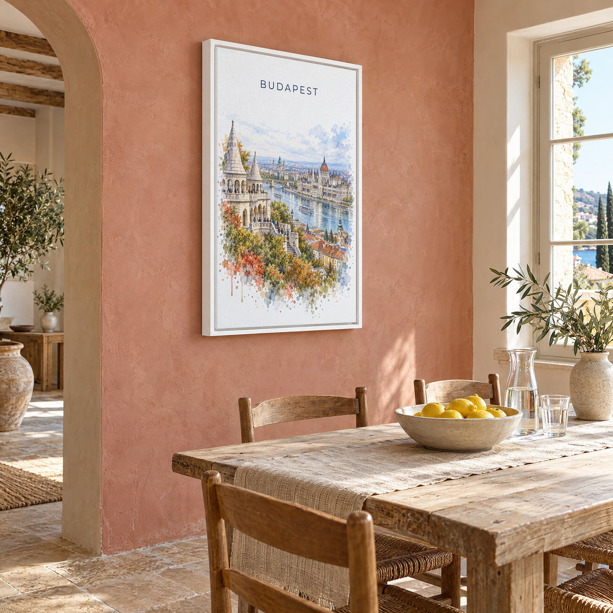 Budapest watercolor print as a white floater canvas on a terracotta wall above a rustic dining table
