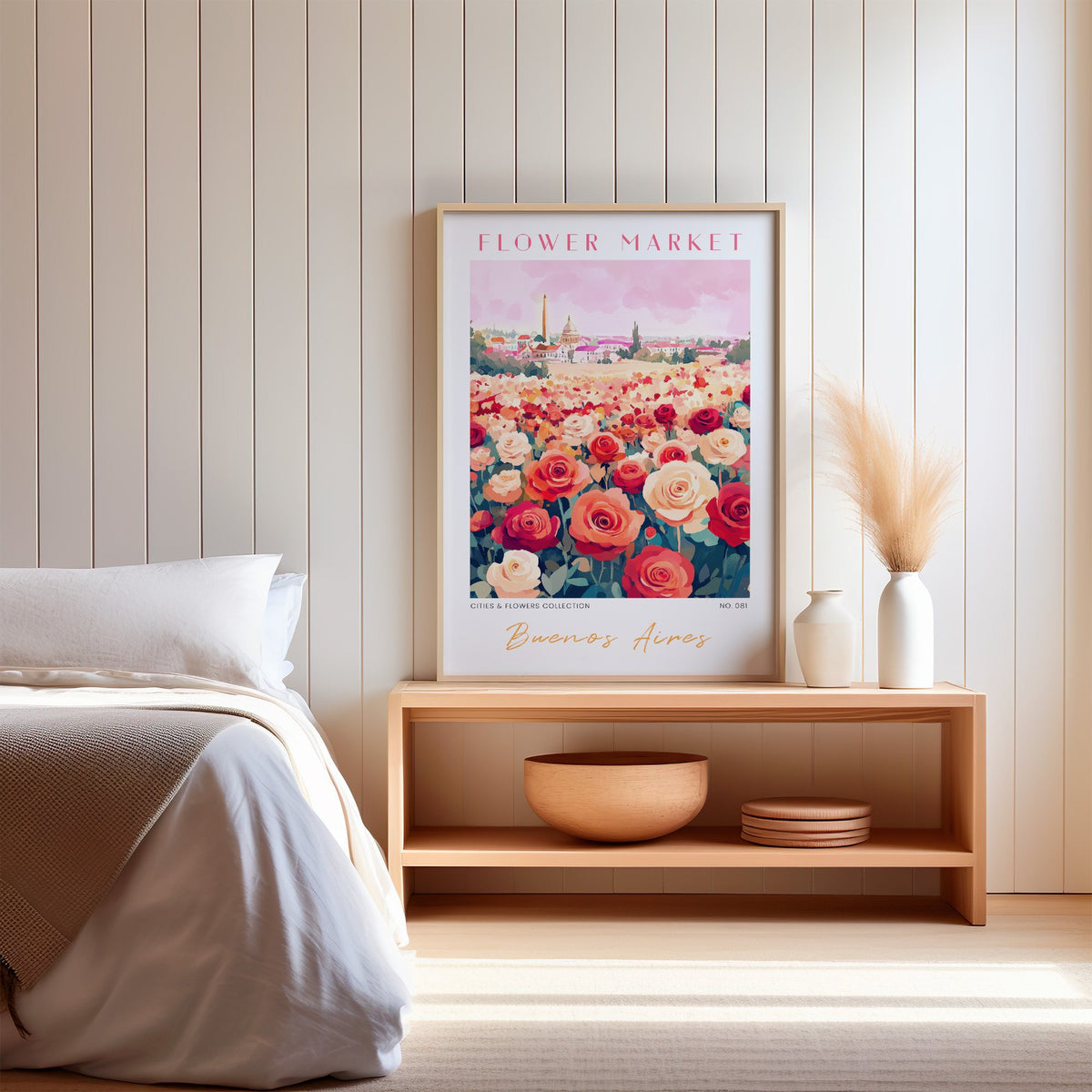 Buenos Aires flower market print in an oak frame on a wood bench against a white shiplap bedroom wall with pampas grass