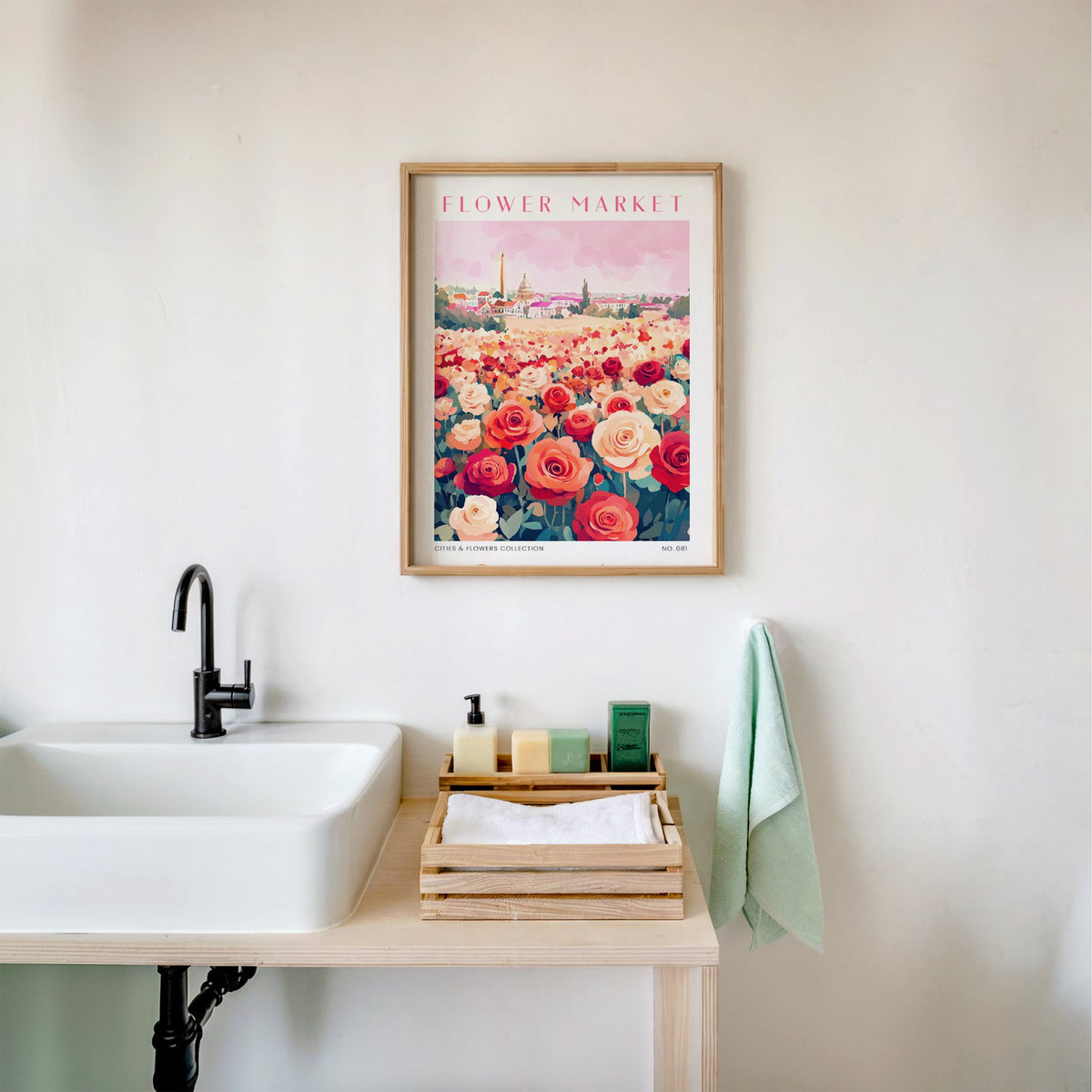Buenos Aires flower market print in an oak frame above a white bathroom sink with folded towels