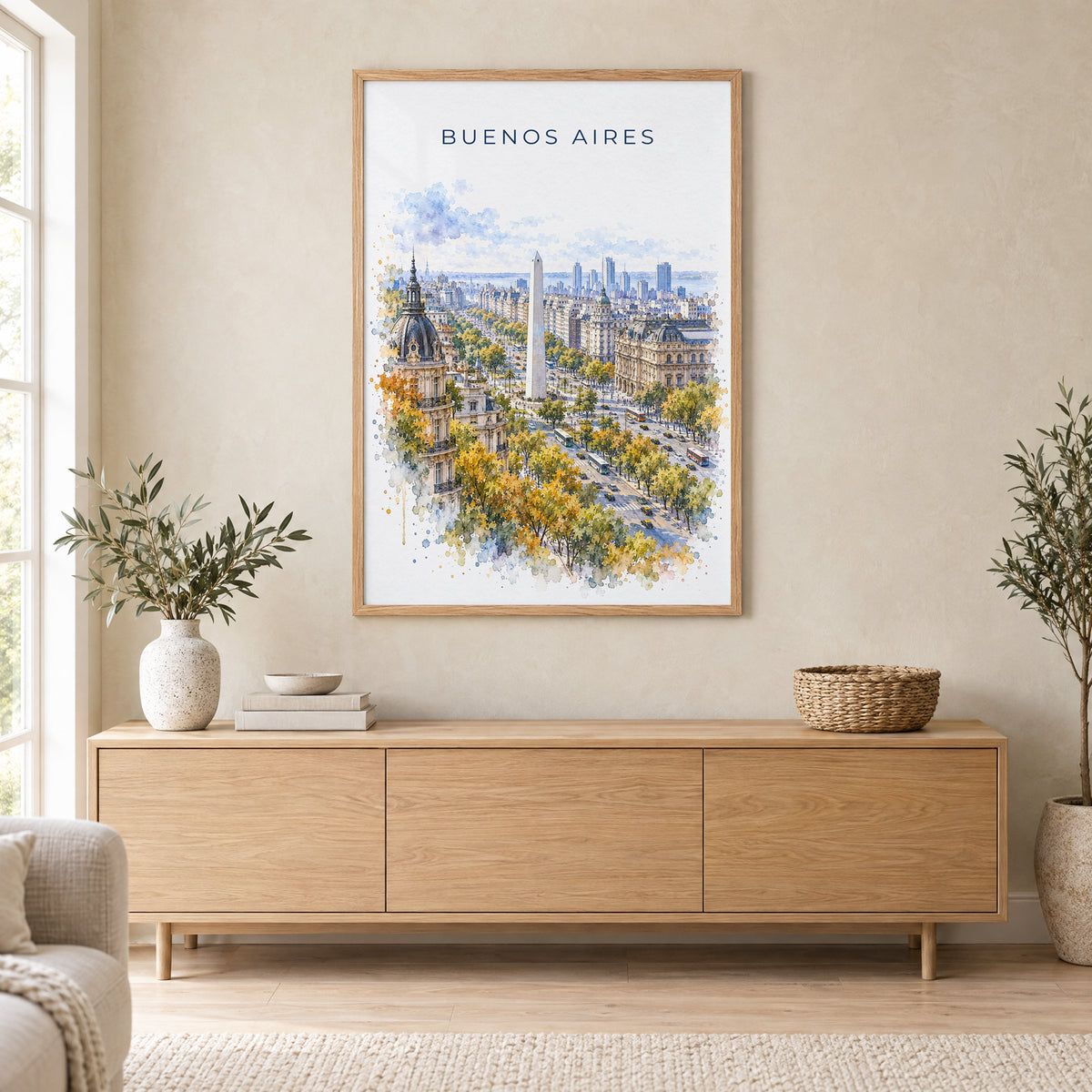 Buenos Aires watercolor print in an oak frame above a light wood sideboard in a Scandinavian living room