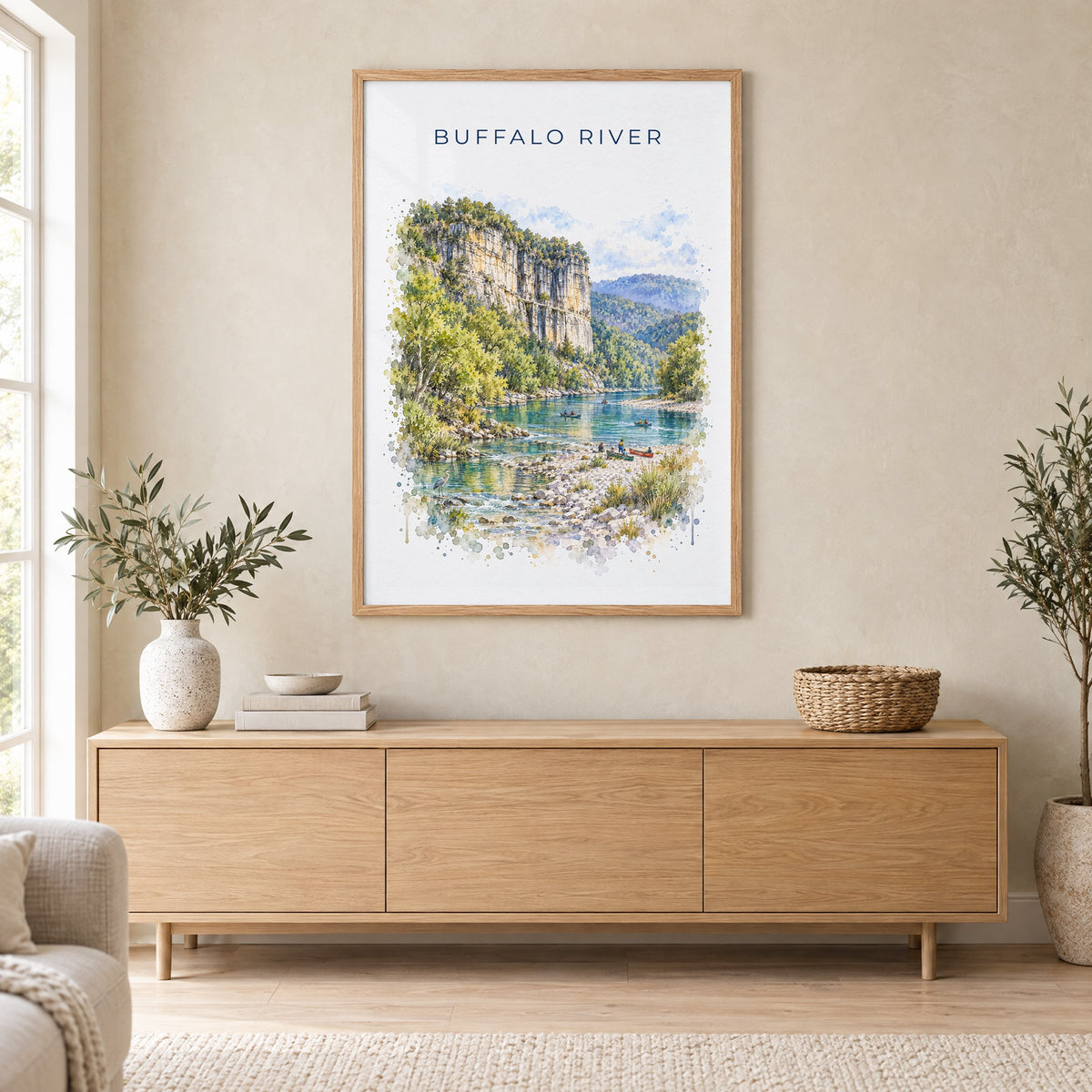 Buffalo National River watercolor print in an oak frame above a light wood sideboard in a Scandinavian living room