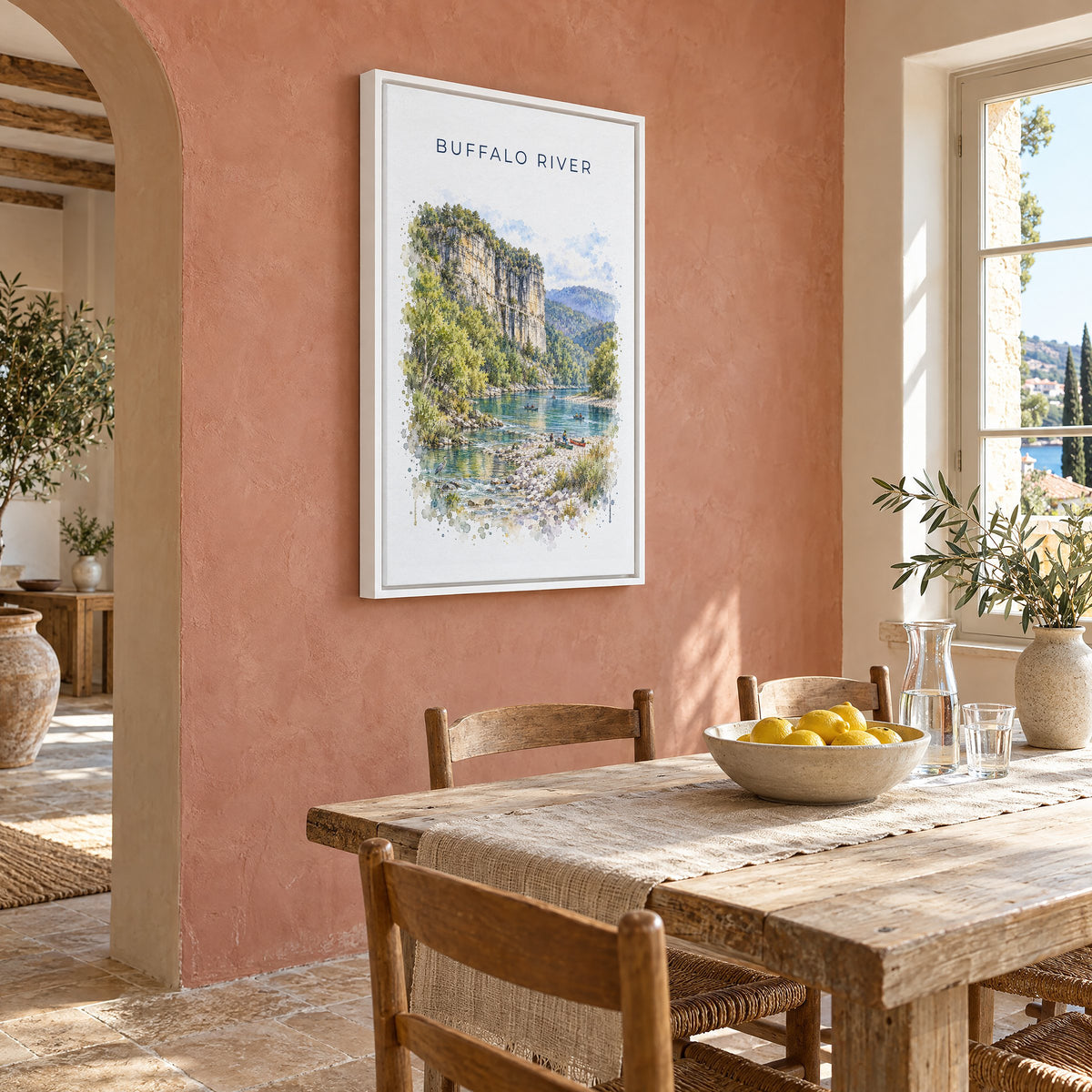 Buffalo National River watercolor print as a white floater canvas on a terracotta wall above a rustic dining table