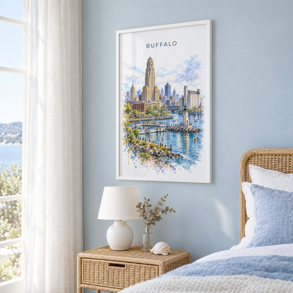 Buffalo watercolor print in a white frame on a pale blue wall beside a rattan bed in a coastal bedroom