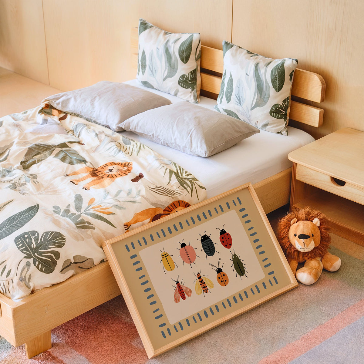 Landscape bug collection chart nursery print in an oak frame leaning on a kids bed by a lion plush