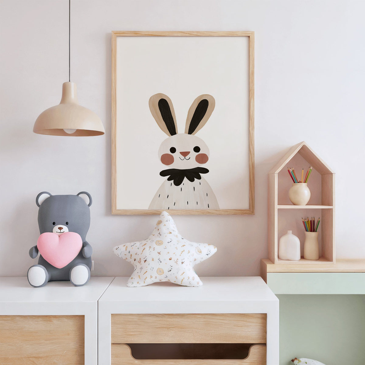Bunny black ruffle collar nursery print in an oak frame above a white dresser with a star pillow and house shelf