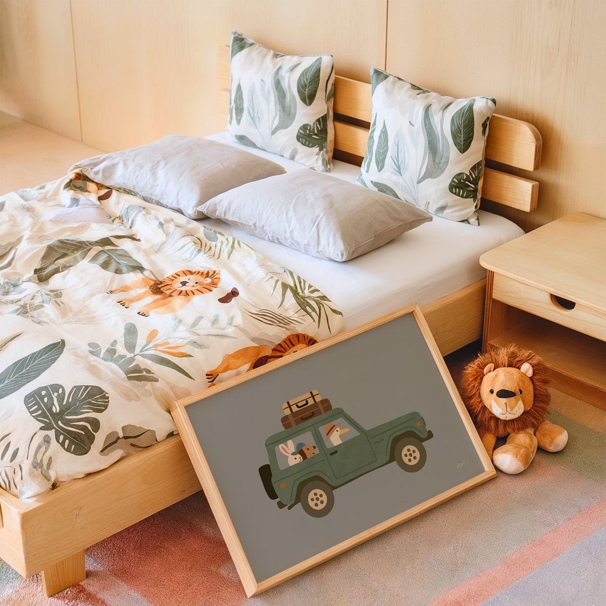Animals riding green vintage suv nursery print in an oak frame leaning on a kids bed by a lion plush