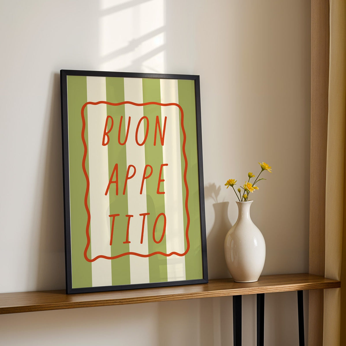 Buon appetito print in a black frame on a console table with yellow daisies
