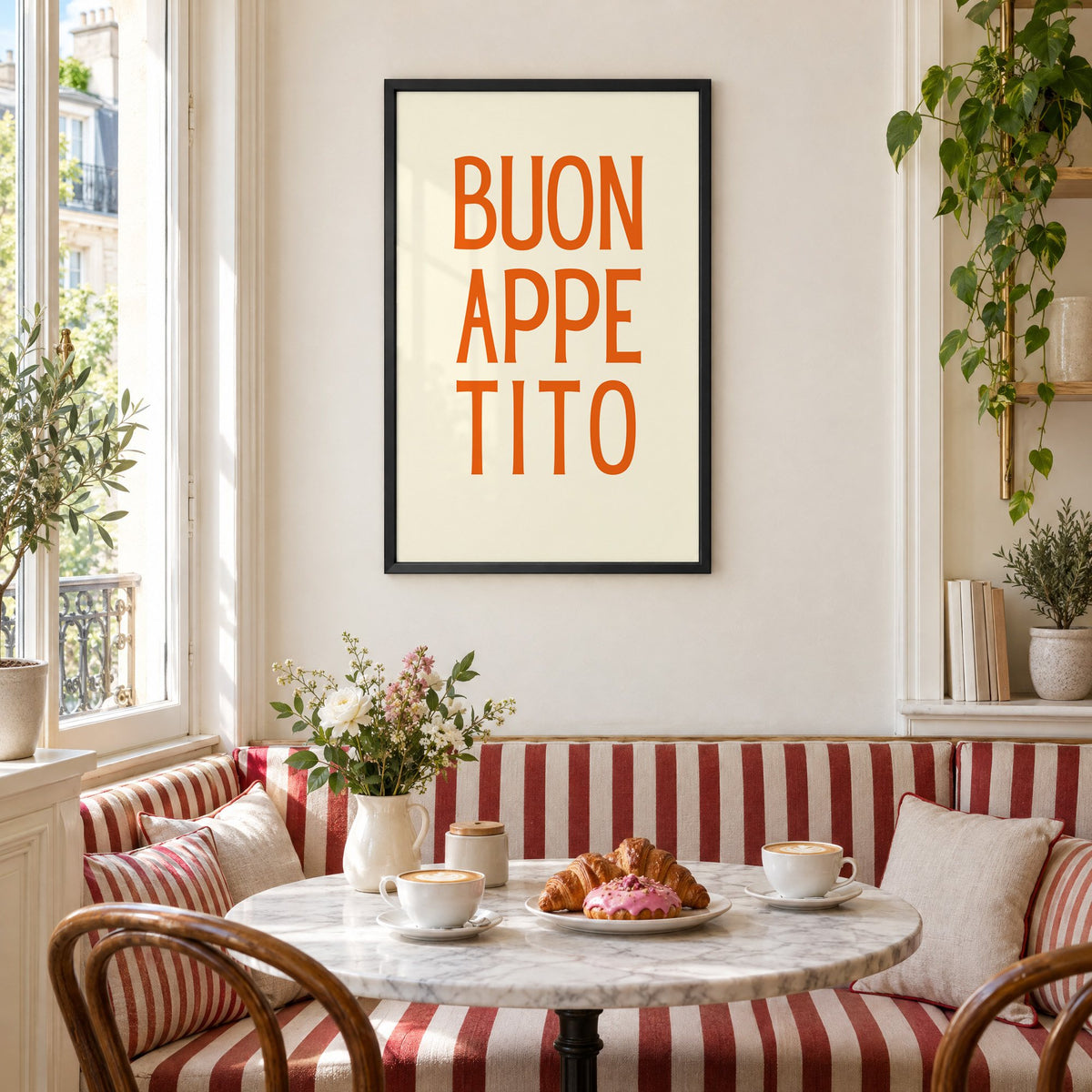BUON APPE TITO orange stacked type print in a black frame above a striped cafe breakfast nook with cappuccino and pastries
