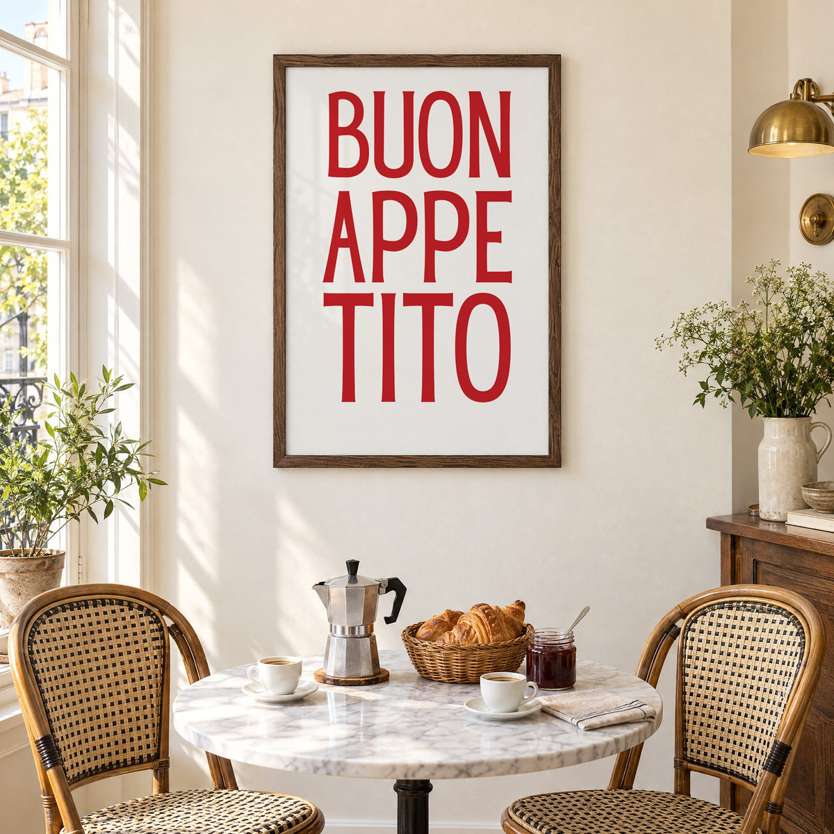 BUON APPE TITO red condensed type print in a walnut frame above a marble bistro table with croissants and rattan chairs
