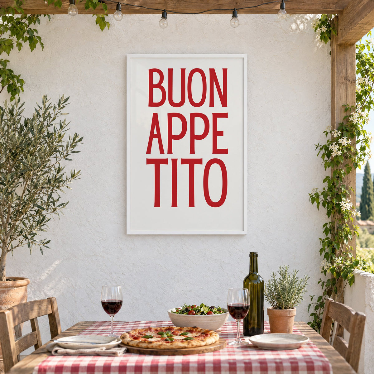 BUON APPE TITO red condensed type print in a white frame on a stucco wall above a checked-cloth table with pizza and red wine