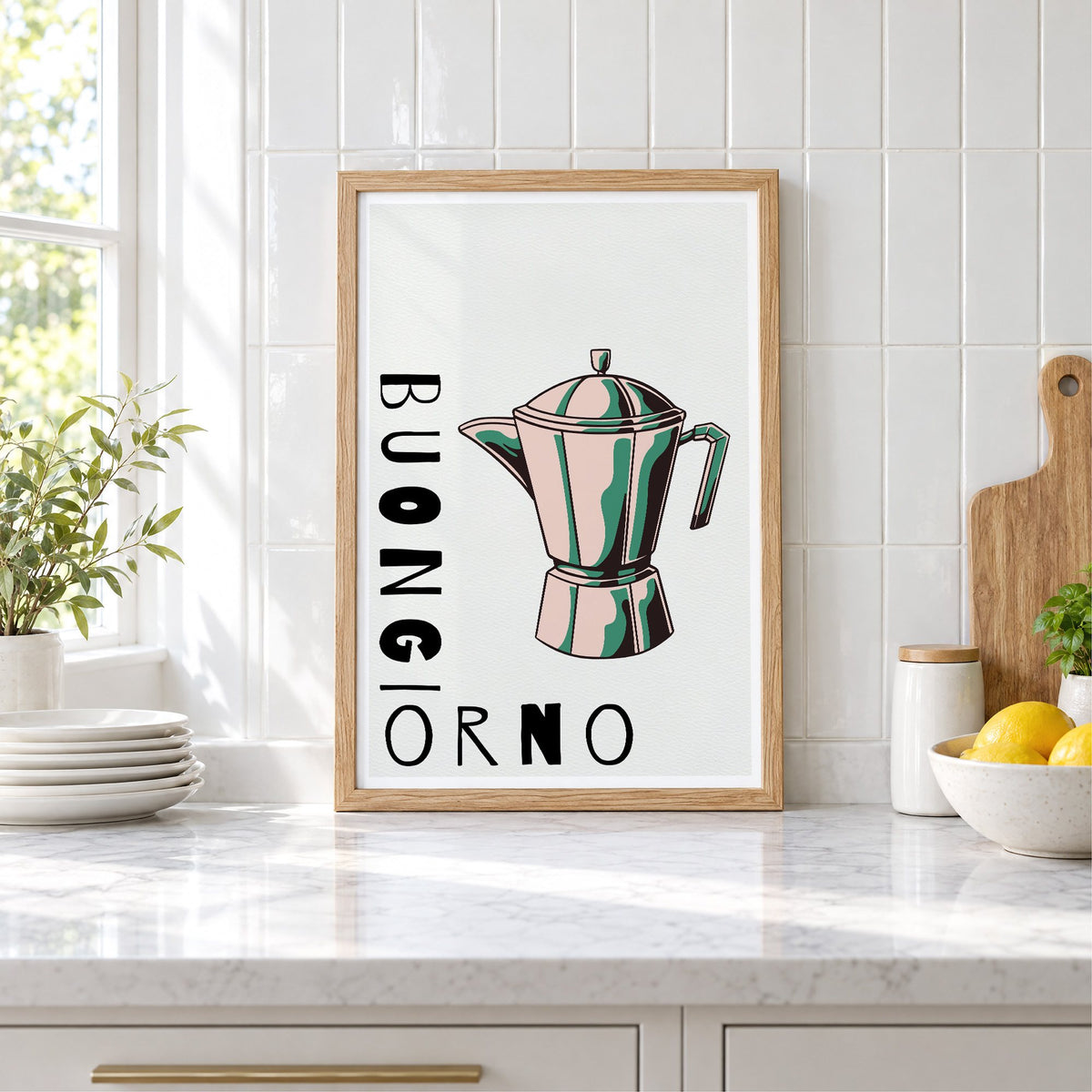 BUONGIORNO moka pot pop art print in an oak frame leaning on a marble counter by white tiles and lemons