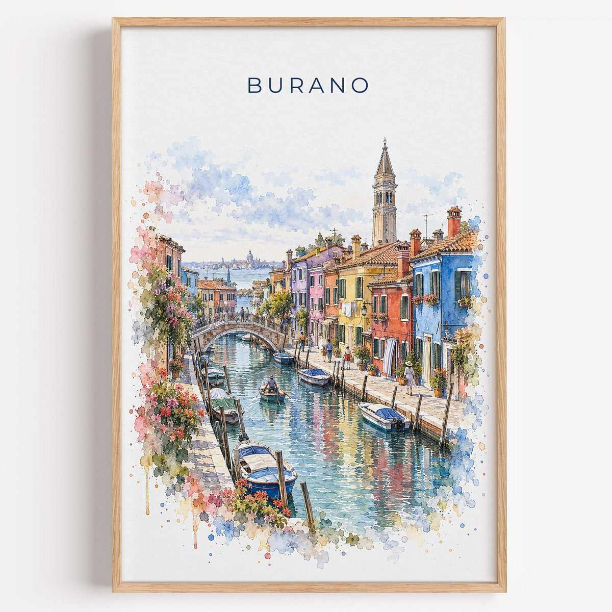 Burano watercolor print in a light oak frame on a plain white wall