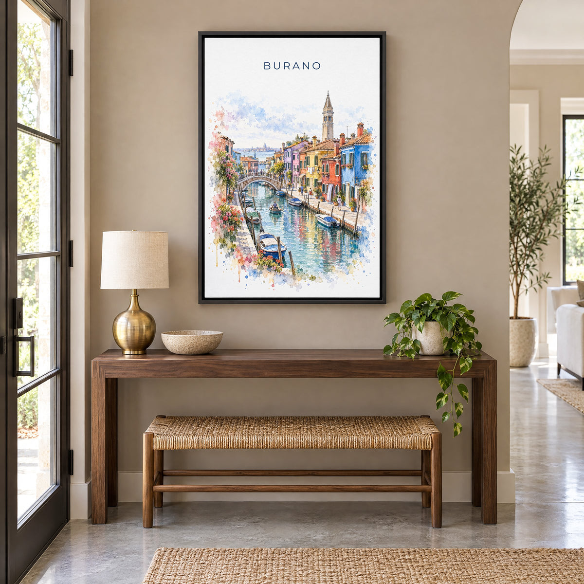Burano watercolor print as a black floater canvas above a walnut console and woven bench in an entryway
