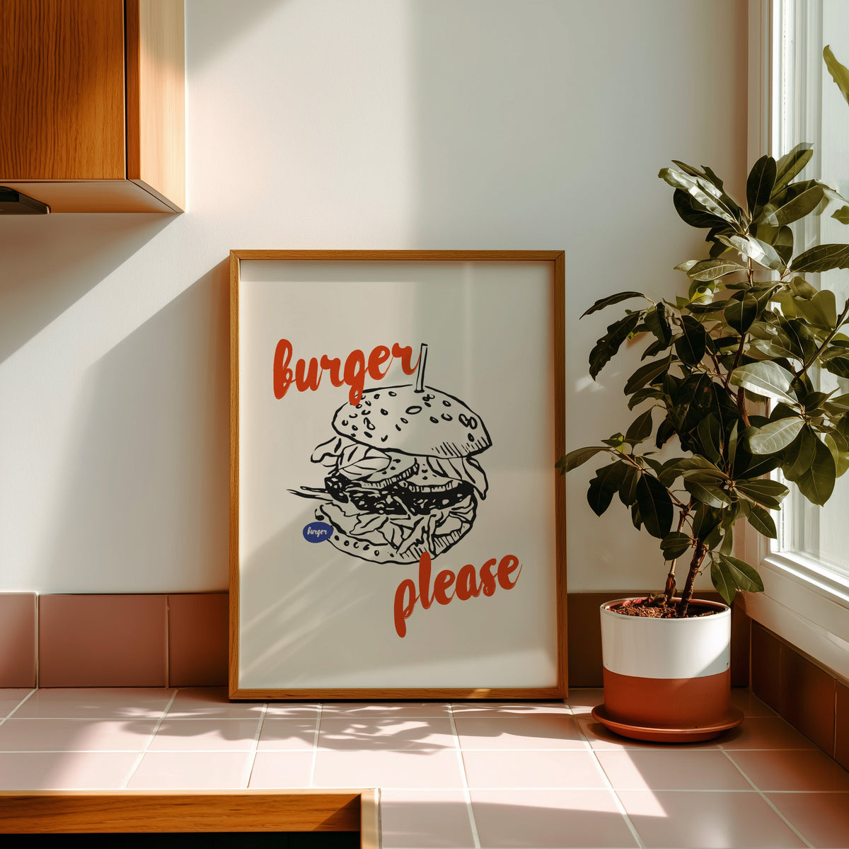 Burger Please print in an oak frame on pink tiles in afternoon sun