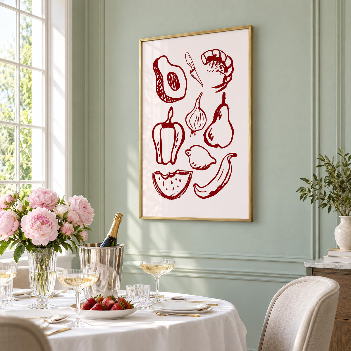 Burgundy line vegetables and fruit sketch print in a brass frame on a sage wall above a brunch table with champagne and peonies, seen at an angle