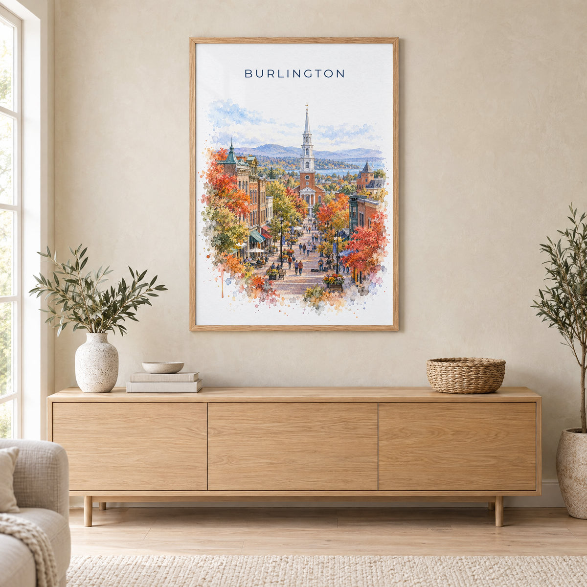 Burlington, Vermont watercolor print in an oak frame above a light wood sideboard in a Scandinavian living room