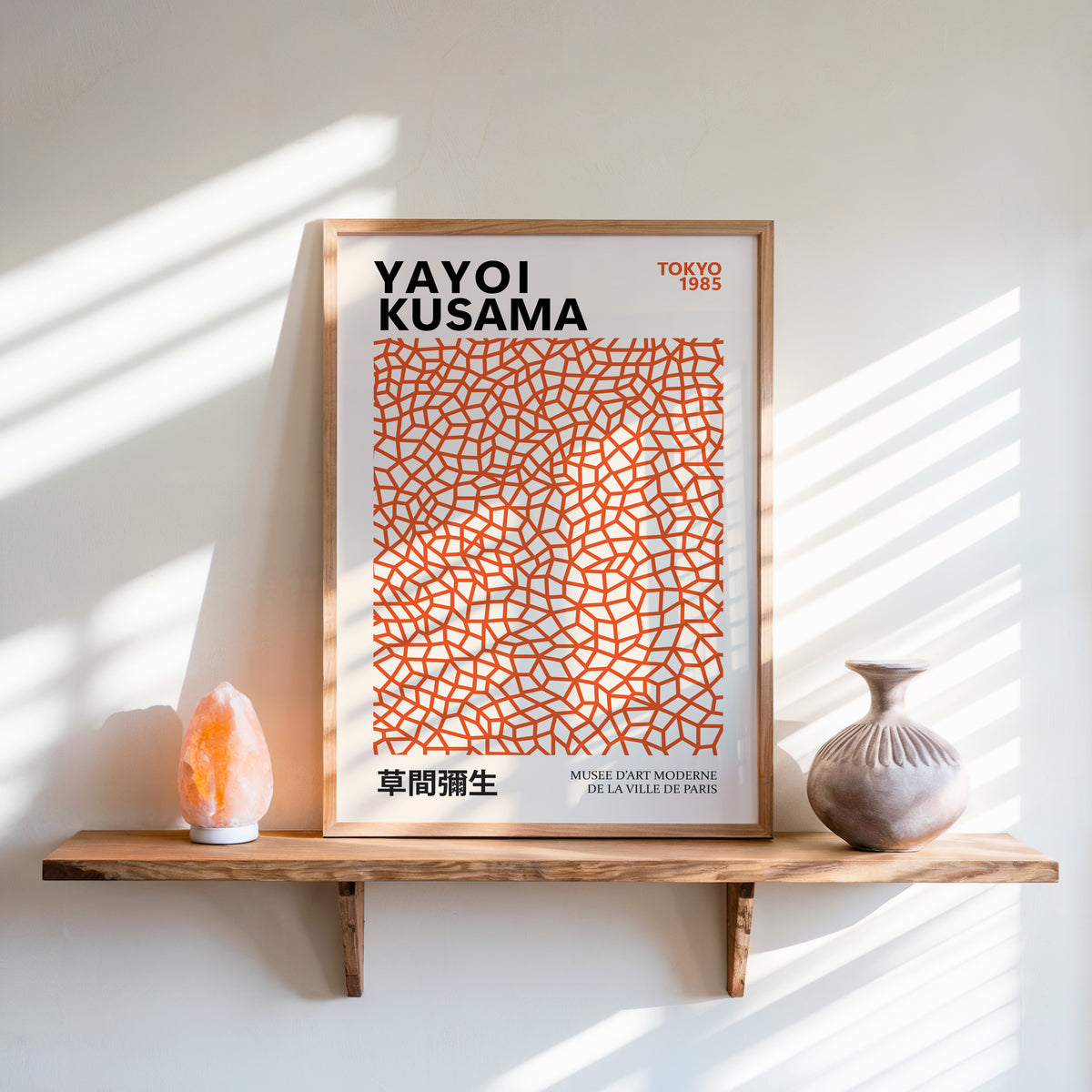 Yayoi Kusama inspired burnt orange net print above a shelf with a salt lamp