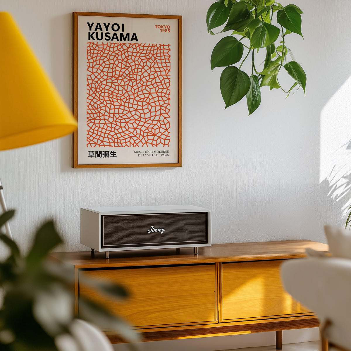 Yayoi Kusama inspired burnt orange net print above a sideboard with a plant