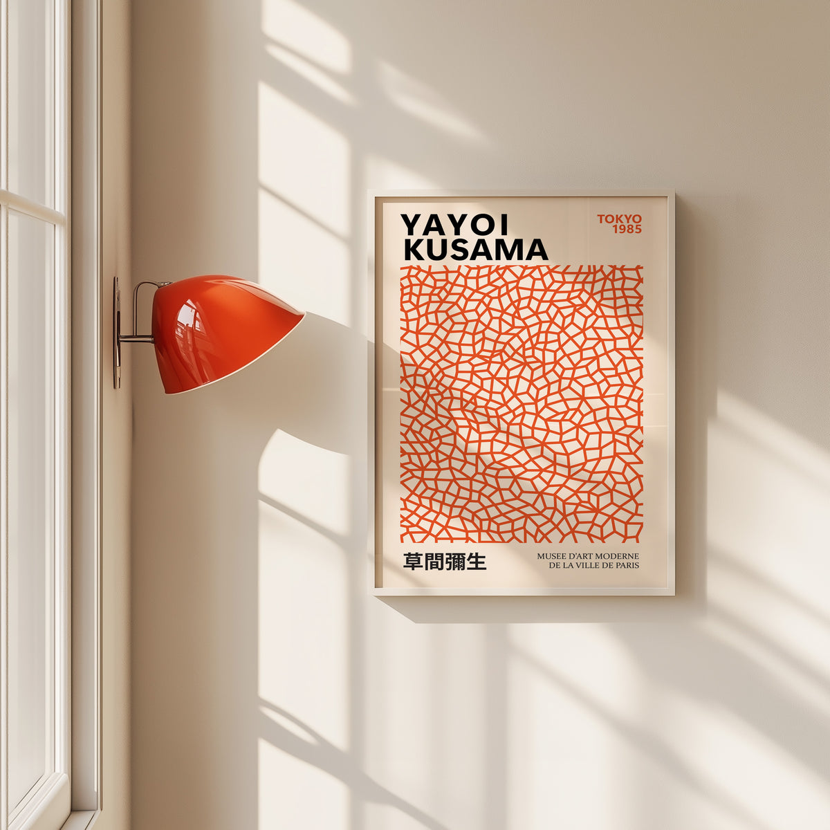 Yayoi Kusama inspired burnt orange net print in a white frame by a red wall lamp