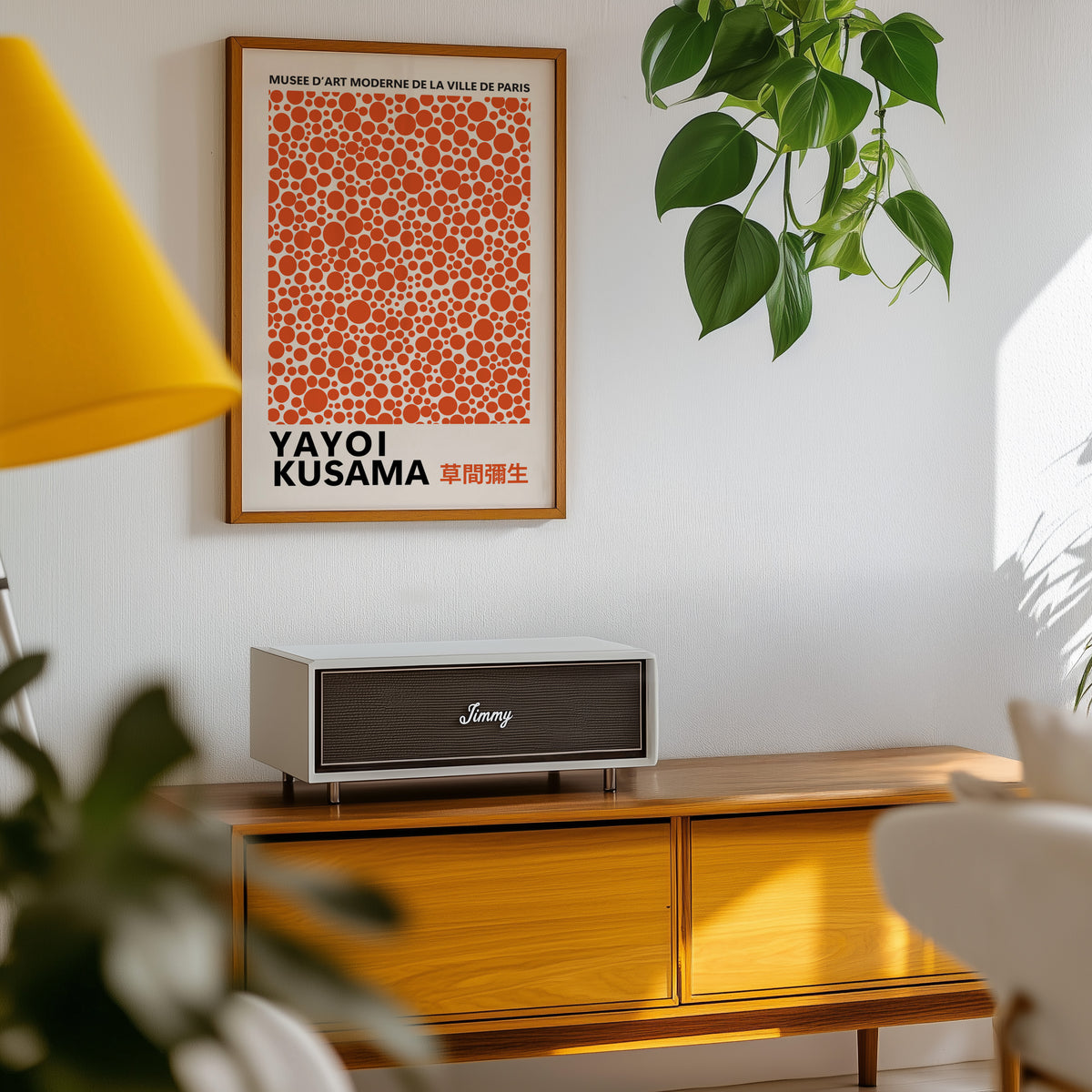 Yayoi Kusama inspired burnt orange polka dot print above a sideboard with a plant