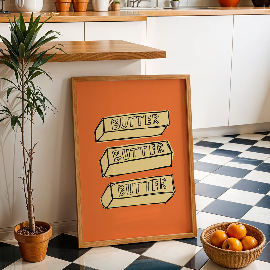 Butter blocks print in an oak frame by a kitchen island and checkered floor
