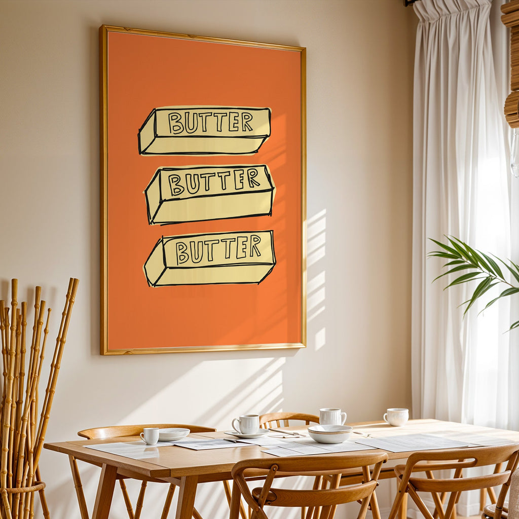 Butter blocks print in a gold frame above a sunlit breakfast table