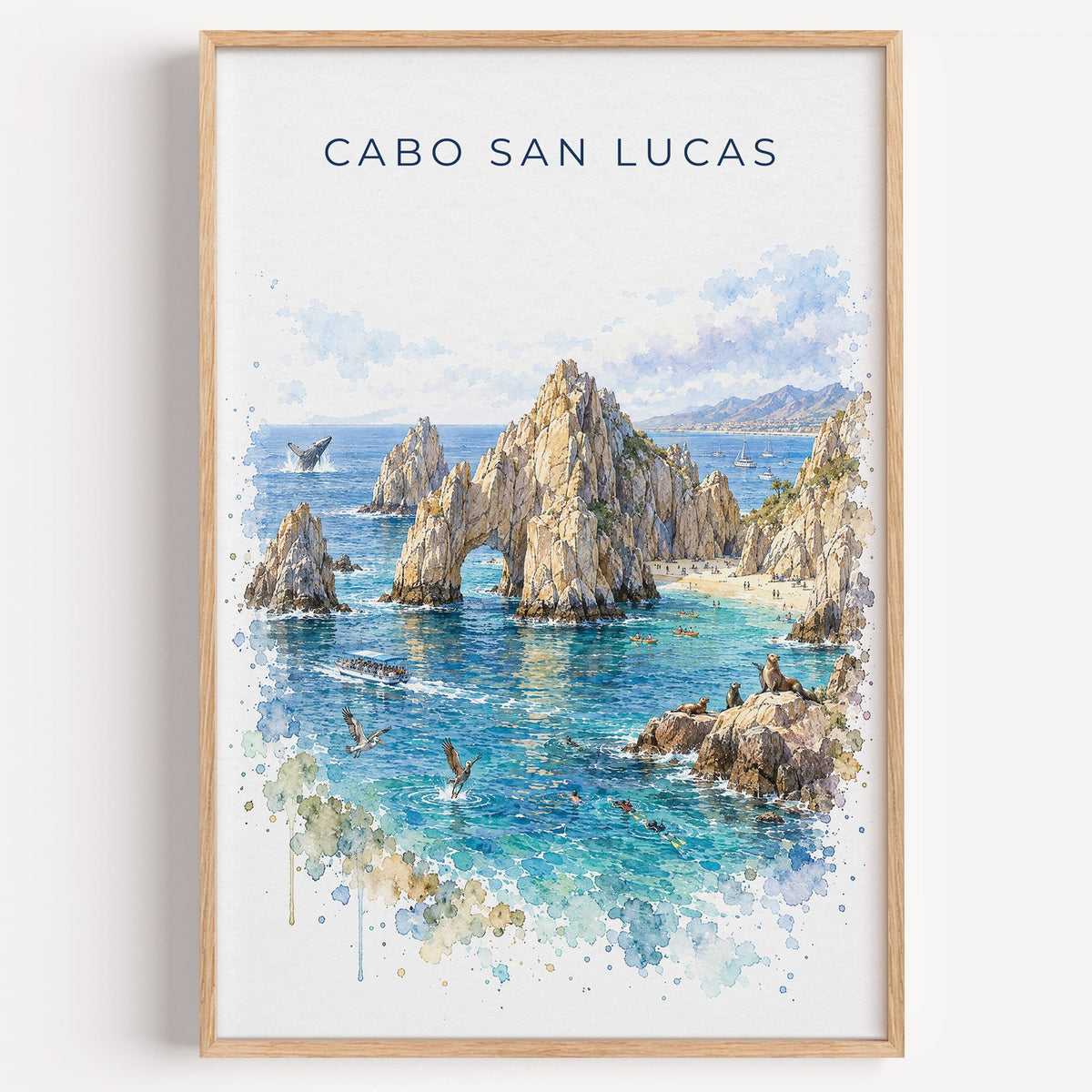 Cabo San Lucas watercolor print in a light oak frame on a plain white wall