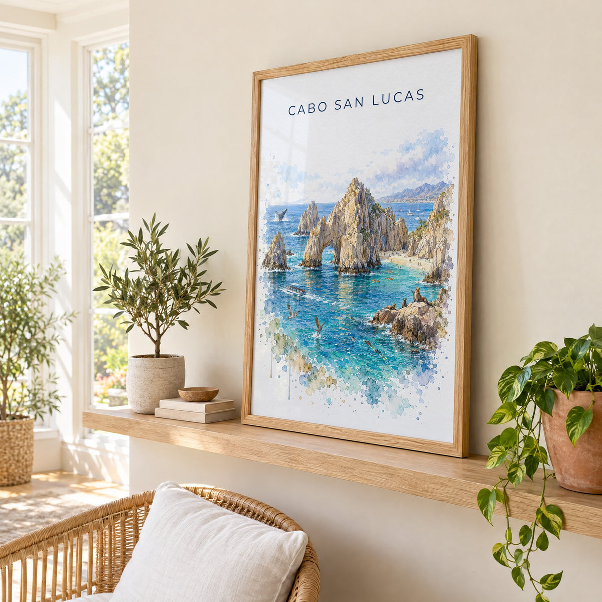 Cabo San Lucas watercolor print in an oak frame on a picture ledge in a sunlit sunroom